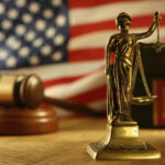 Immigration: Lady scales of Justice in front of the American flag and a gavel
