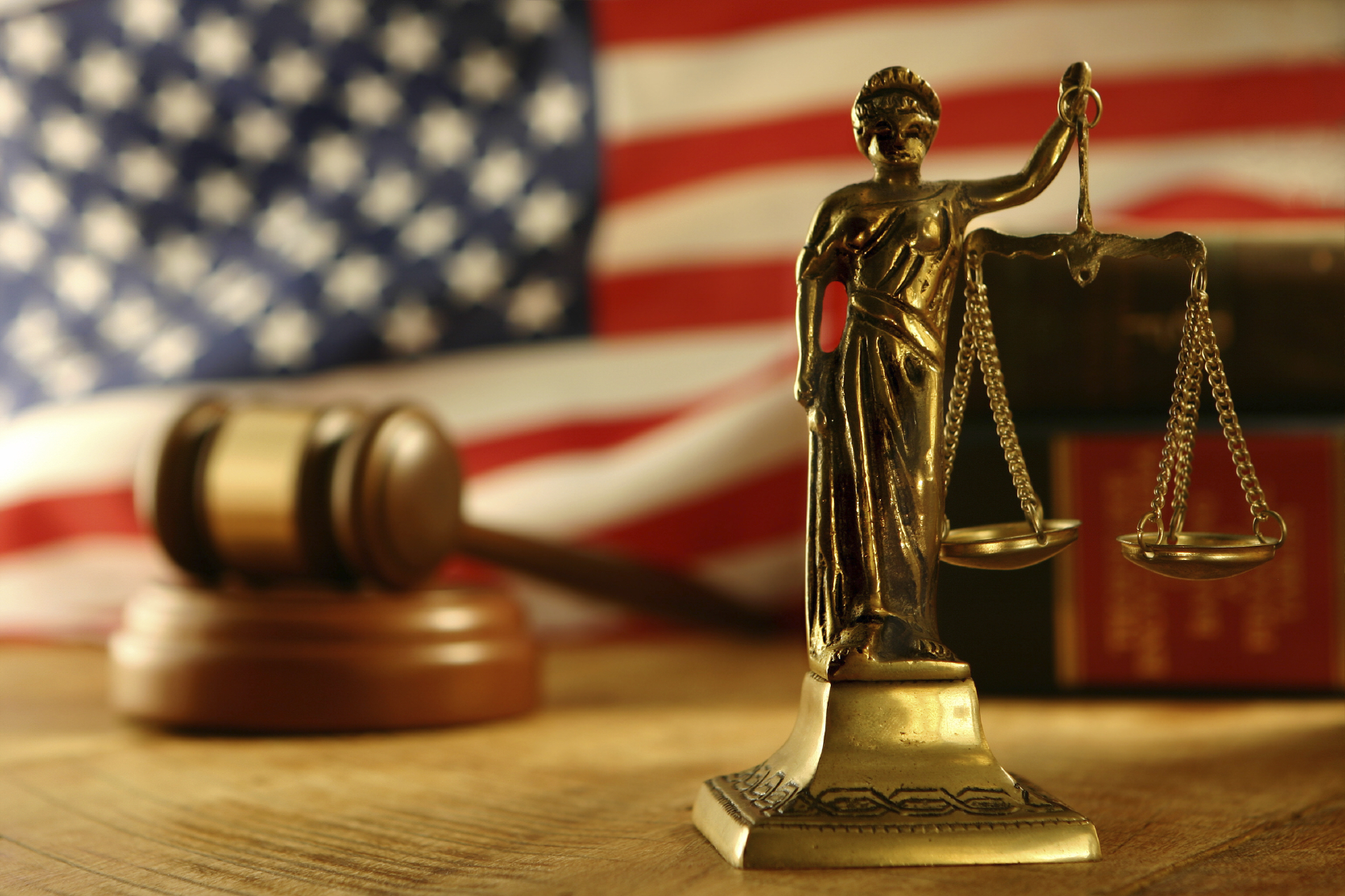 Immigration: Lady scales of Justice in front of the American flag and a gavel